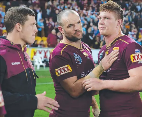  ?? Picture: PETER WALLIS ?? Jarrod Wallace (left) with Nate Myles (centre) and Dylan Napa (right) on the field after Queensland’s Game One loss.