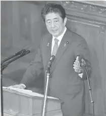  ?? AFP PHOTO ?? DIVISIVE ISSUE
Japanese Prime Minister Shinzo Abe delivers his policy speech at the lower house of the parliament in Tokyo on Friday.