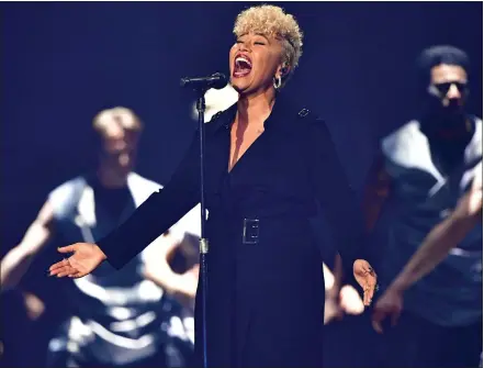  ??  ?? Emeli Sande on stage, above, while below, receiving her MBE at Buckingham Palace in February