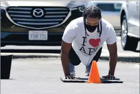  ?? PHOTOS BY JOEL ROSENBAUM — THE REPORTER ?? Cassius Reynolds, 21 of Vacaville does push-ups while working outside during a fitness boot camp at Fitness Explosion in August.