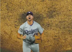  ?? David J. Phillip / Associated Press ?? Dodgers reliever Blake Treinen celebrates after closing out his team’s Game 5 victory over the Rays in the World Series. Treinen allowed a leadoff single in the ninth, then retired the next three batters — two by strikeout.