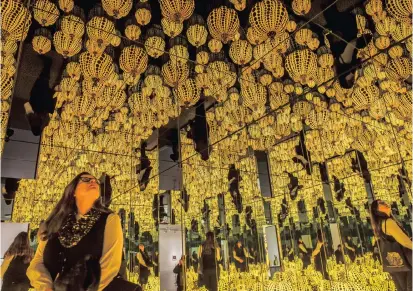  ?? Picture: WASHINGTON POST/BILL O’LEARY ?? SHOWING OFF: Volunteer Megan Walline experience­s Kusama’s installati­on ‘All the Eternal Love I Have for the Pumpkins’. series finale of