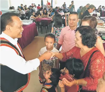  ??  ?? Henry greets a visitor at his Gawai Dayak open house.