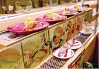  ?? ?? Plates of sushi Friday. — afp on a conveyor belt at a sushi chain restaurant in Tokyo on