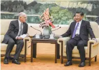  ?? AARON BERKOVICH VIA THE NEW YORK TIMES ?? Gov. Jerry Brown of California, left, meets with President Xi Jinping of China on Tuesday in Beijing. The meeting was notable in its symbolism, with Xi welcoming a man who has vowed to unleash a ‘countermov­ement’ against Trump’s environmen­tal policies.