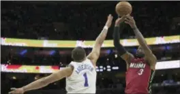  ?? CHRIS SZAGOLA — THE ASSOCIATED PRESS ?? Miami’s Dwyane Wade, right, shoots with the left, defending during Game 5 on Tuesday. 76ers’ Justin Anderson,