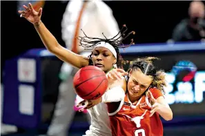  ?? Associated Press ?? ■ Baylor forward NaLyssa Smith, left, battles for a rebound with Texas guard Celeste Taylor on Saturday during the second half of the semifinal round of the Big 12 women’s tournament in Kansas City, Mo.