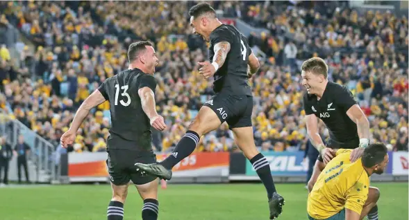  ?? Photo: Zimbio ?? Ryan Crotty of the All Blacks (13) celebrates with teammates Aaron Smith (middle), and Beauden Barret after scoring a try during The Rugby Championsh­ip Bledisloe Cup match against the Australian Wallabies at ANZ Stadium on August 19, 2017 in Sydney,...