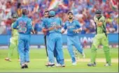  ?? GETTY FILE ?? Indian players celebrate a wicket in 2015 clash.