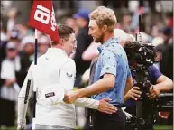  ?? Warren Little / Getty Images ?? Matt Fitzpatric­k, left, shakes hands with Will Zalatoris after Fitzpatric­k’s victory on the 18th green at the U.S. Open Sunday in Brookline, Mass.