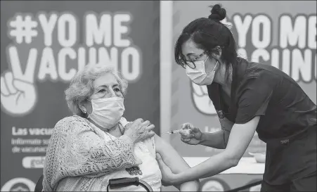  ?? JORGE VILLEGAS / XINHUA ?? An elderly woman in Santiago, Chile, receives CoronaVac made by China’s Sinovac Biotech Ltd. Chile started administer­ing vaccines on Feb 3, including nearly 4 million doses received from China.