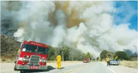  ?? (Reuters) ?? CREWS BATTLE the so-called Sand Fire in the Angeles National Forest near Los Angeles, California, Sunday.