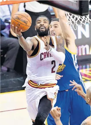  ?? JASON MILLER/GETTY IMAGES ?? Cleveland’s Kyrie Irving, who finished with 40 points on 15-of-27 shooting (including 7 3-pointers) from the field, drives to the basket against Golden State’s Klay Thompson in the Cavaliers’ Game 4 victory.