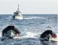  ??  ?? A Libyan coastguard vessel chases away a humanitari­an ship in the Mediterran­ean