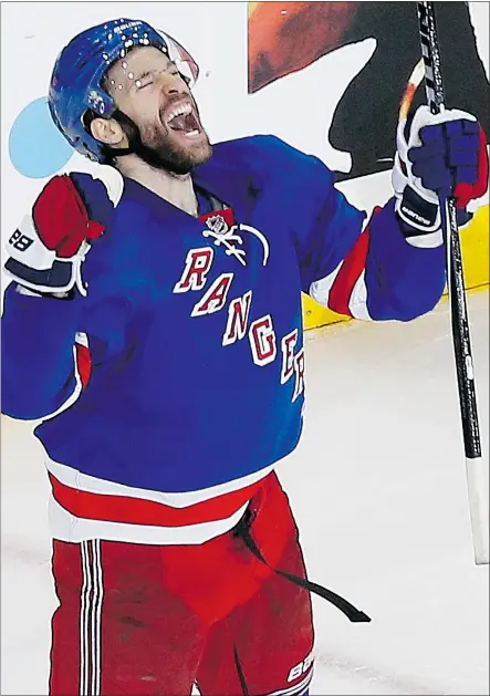  ?? — AP ?? New York Rangers centre Dominic Moore celebrates his game-winning goal against the Tampa Bay Lightning in Game 1 of the Eastern Conference final Saturday in New York. The Rangers won 2-1.