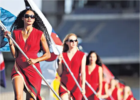  ??  ?? On parade: grid girls fly the flag at the German Grand Prix in Hockenheim