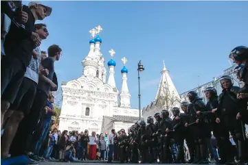  ??  ?? Opposition supporters oppose riot police during an unauthoris­ed anti-Putin rally called by opposition leader Alexei Navalny, in Moscow, two days ahead of Vladimir Putin’s inaugurati­on for a fourth Kremlin term. — AFP photo