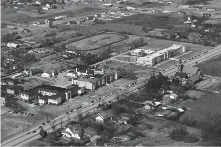  ?? BARNEY SELLERS/THE COMMERCIAL APPEAL ?? April 12, 1953: Whitehaven High School and Whitehaven Elementary School are seen in this aerial photograph. Elvis Presley Boulevard is visible running diagonally at bottom portion of image. Whitehaven Baptist Church is seen at far right center. The photograph is taken looking toward the northwest.