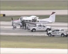  ?? WPTV VIA AP ?? In this still image from video by WPTV shows emergency personnel surroundin­g a Cessna plane at
Palm Beach Internatio­nal Airport on Tuesday in West Palm Beach, Fla.