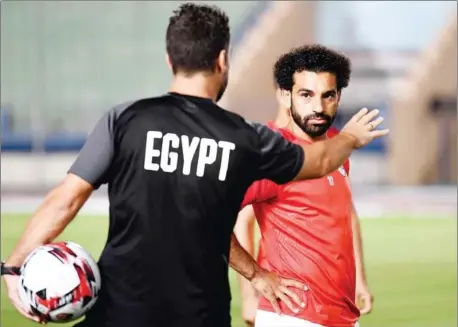  ?? KHALED DESOUKI/AFP ?? Egypt’s forward Mohamed Salah listens to a coach during a training session on Wednesday at the Cairo Military Academy Stadium in the Egyptian capital two days ahead of their opening match against Zimbabwe in the 2019 football Africa Cup of Nations.