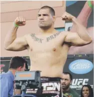  ??  ?? UFC heavyweigh­t fighter Cain Velasquez, weighing in before an October 2010 bout, is out of Friday’s UFC 207 card due to medical issues. Josh Hedges, Getty Images