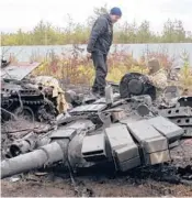  ?? EFREM
LUKATSKY/AP ?? A Ukrainian soldier examines a Russian military vehicle on Saturday in the village of Dmytrivka, Ukraine.