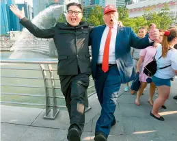  ?? — AFP ?? North Korean leader Kim Jong Un impersonat­or Howard X and Donald Trump impersonat­or Dennis Alan react at the Merlion park in Singapore on Friday.