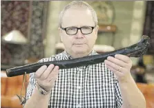  ?? DEREK RUTTAN ?? Grant Gardner of Gardner Galleries Fine and Fine Art Auctioneer­s in London, Ont., displays a shillelagh once owned by Robert Donnelly of Lucan’s infamous Donnelly family.