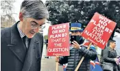  ??  ?? Jacob Rees-mogg, chairman of the European Research Group, arrives at Westminste­r for the motion of no confidence, to be greeted by an anti-brexit protester