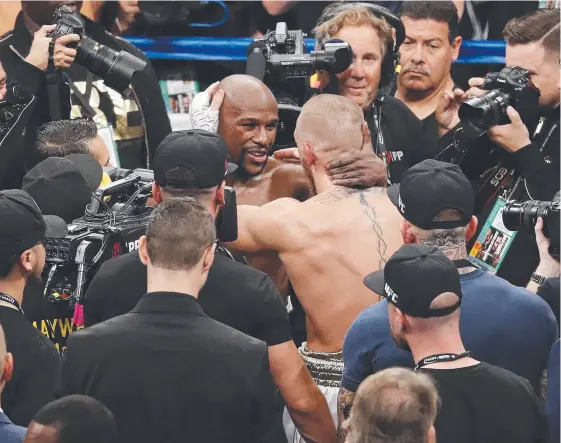  ?? Picture: AP ?? Floyd Mayweather embraces Conor McGregor after their fight in Las Vegas yesterday.