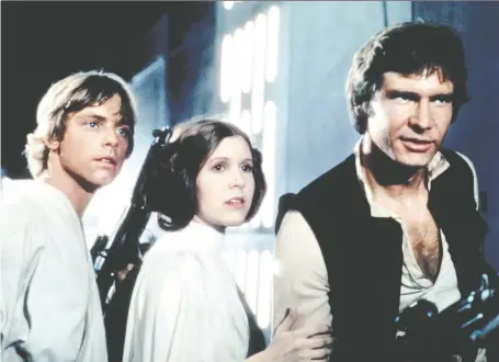  ??  ?? Mark Hamill, left, Carrie Fisher and Harrison Ford were the terrific trio in A New Hope, the movie that launched the Star Wars franchise back in 1977.