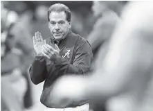 ?? STAFF FILE PHOTO BY C.B. SCHMELTER ?? Alabama coach Nick Saban claps as his team warms up before the Jan. 8 playoff championsh­ip game against Georgia in Atlanta. The AP preseason Top 25 is out, and for the third straight year Alabama is No. 1.