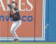  ?? MARK BLINCH, AP ?? The Orioles’ Hyun Soo Kim gets under a fly ball as a beer can falls near him in Toronto in last October’s wild-card game.