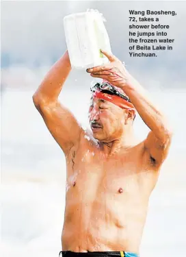  ??  ?? Wang Baosheng, 72, takes a shower before he jumps into the frozen water of Beita Lake in Yinchuan.