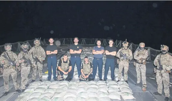  ?? Picture: Royal Navy ?? HMS Lancaster sailors and Royal Marines pictured alongside the haul of hashish.