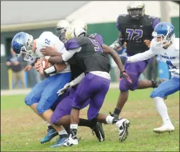  ?? Photo by Ernest A. Brown ?? Cumberland quarterbac­k Joe Leonard can't avoid the pressure as the St. Raphael defense records a sack during Saturday's game at Pariseau Field.