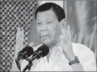  ?? AP/ AARON FAVILA ?? Philippine President Rodrigo Duterte speaks at a ceremony with the Philippine­s military Tuesday at the presidenti­al palace in Manila, the same day he asked Congress to extend martial law in the country’s south.