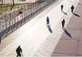  ?? AFP ?? In an aerial view from a drone, visitors take to the boardwalk in Long Beach, New York.