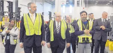  ?? DAVID ANDERSON/BALTIMORE SUN MEDIA ?? Piyush Bajpai, right, general manager of Amazon’s distributi­on center in Cecil County, guides U.S. Rep. Andy Harris, left and Gov. Larry Hogan on a tour of the facility on Feb. 14, 2019.