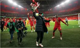  ?? Photograph: Tom Jenkins/The Guardian ?? Jürgen Klopp celebrates with the Carabao Cup after Liverpool’s penalty shootout triumph against Chelsea at Wembley.