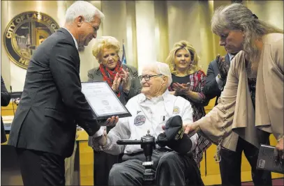  ?? Erik Verduzco ?? Las Vegas Review-journal Pearl Harbor survivor retired Navy Lt. Jim Downing receives recognitio­n from the Las Vegas City Council on Wednesday. The 104-year-old is the second-oldest known living survivor of the Japanese attack on Dec. 7, 1941.