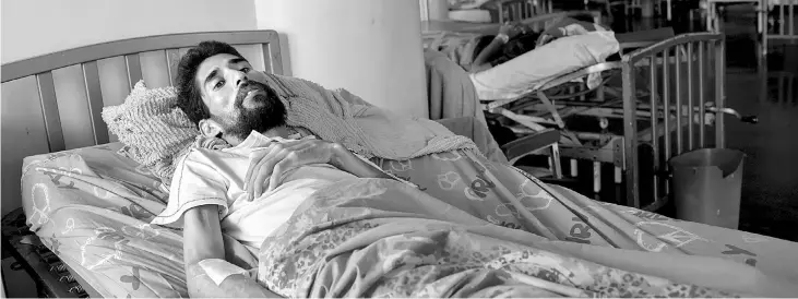  ??  ?? HIV patient Morales lies on a bed in at Caracas University Hospital in Venezuela on Aug 7. — WP-Bloomberg photos