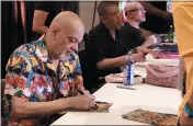  ?? PAUL BUTTERFIEL­D — GETTY IMAGES ?? George Perez signs autographs at the Las Vegas Convention Center in Las Vegas. He died Friday.