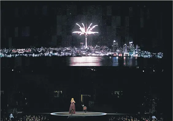  ?? Pictures / Getty Images ?? Visuals of local landmarks, including the Sky Tower, filled the screens above Adele as she powered through Hometown Glory.