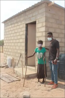  ?? Photo: John Muyamba ?? Generous… Martha Hamusira, pictured in front of her new home with one of the good Samaritans, Antonio George, who assisted her.