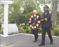  ?? Rob Ryser / Hearst Connecticu­t Media ?? Danbury Police Chief Patrick Ridenhour and Mayor Mark Boughton place a memorial wreath at the Public Safety Memorial Park on Main Street on Thursday.