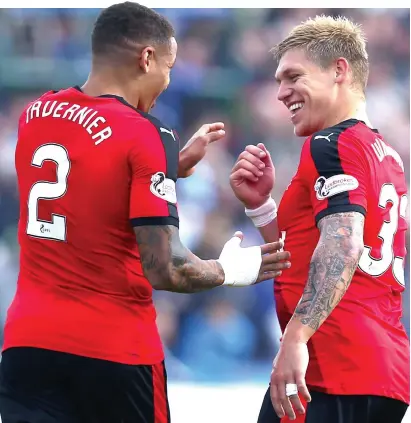  ??  ?? Double act: Tavernier celebrates his goal with fellow scorer Waghorn after putting Rangers 3-0 in front