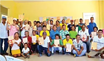  ??  ?? Showing off their land titles were the farmer beneficiar­ies awarded with their Certificat­es of Land Ownership Award. Seated center ( left to right) Gutalac Vice- Mayor Herminio Jamandron, Mayor Onesimo Coma, Jr., PARPO II Mohammad Dassan J. Adju, and...