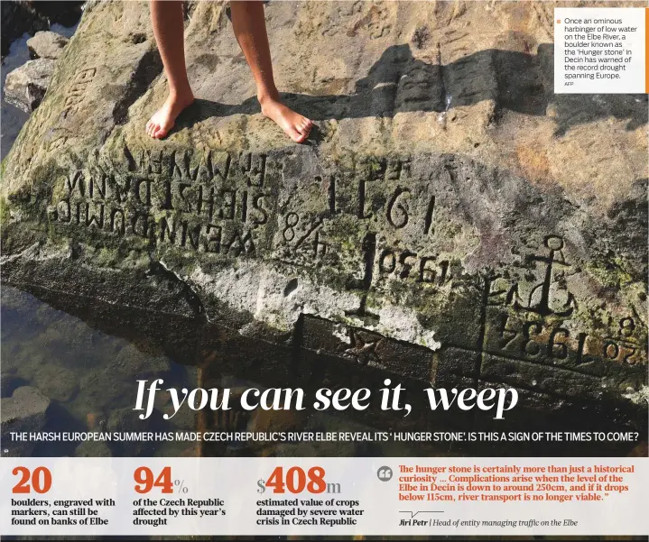  ?? AFP ?? Once an ominous harbinger of low water on the Elbe River, a boulder known as the ‘Hunger stone’ in Decin has warned of the record drought spanning Europe.