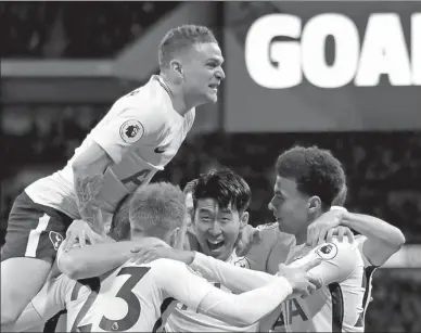  ?? REUTERS ?? Tottenham players mob teammate Christian Eriksen (23) after the Dane scored just 11 seconds into Wednesday’s English Premier League match against Manchester United at Wembley. Spurs won 2-0.